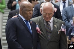 Rep. Paul Tonko, right, puts his arm around Rep. John Lewis.