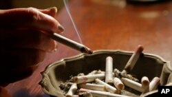 FILE: Representative illustration of a person smoking a cigarette. Taken 3.2.2013