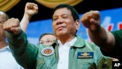 Philippine President Rodrigo Duterte poses with a fist bump during his "Talk with the Airmen" on the anniversary of the 250th Presidential Airlift Wing, Sept. 13, 2016, at the Philippine Air Force headquarters in suburban Pasay city, southeast of Manila. 