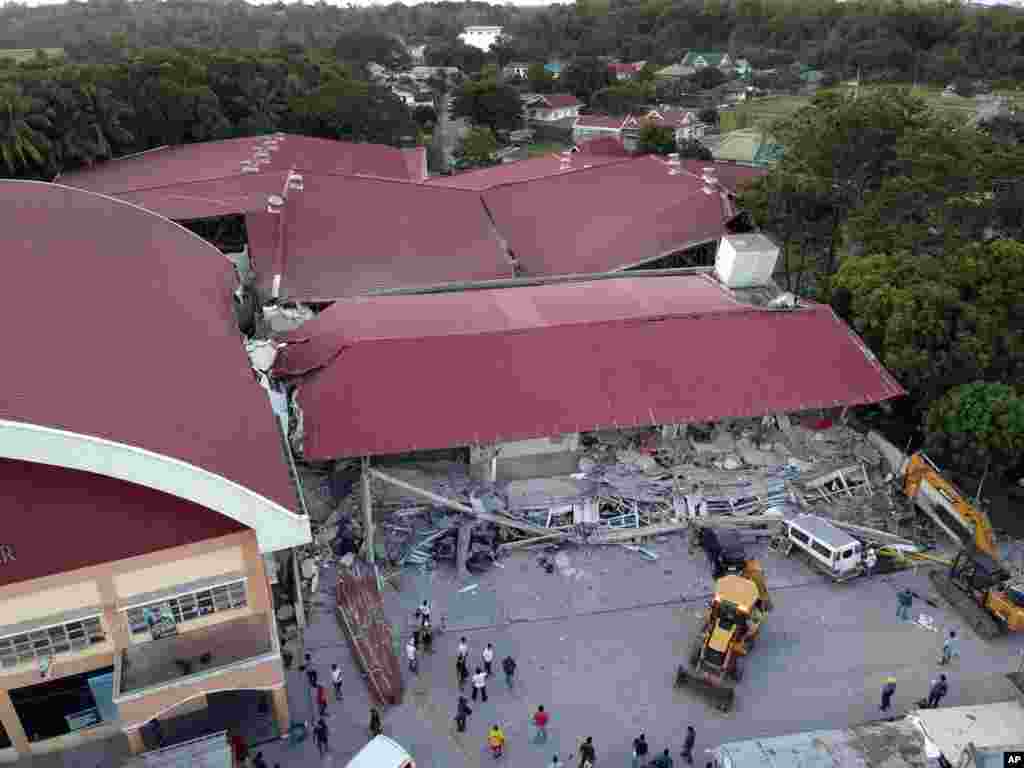 Workers continue to rescue people still trapped inside a collapsed building at Porac town, Pampanga province, northern Philippines. A strong 6.1-magnitude earthquake in the north Philippines trapped some people in a collapsed building, damaged an airport terminal and knocked out power in at least one province, officials said.