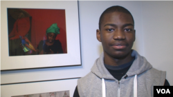 Christopher Neal with one of his photographs in the Studio Museum of Harlem's student show. (Carolyn Weaver/VOA)