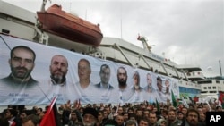 A banner depicting the faces of the nine men killed, displayed on the Mavi Marmara ship, the lead boat of a flotilla headed to the Gaza Strip which was stormed by Israeli naval commandos in a predawn confrontation in the Mediterranean May 31, 2010, on its