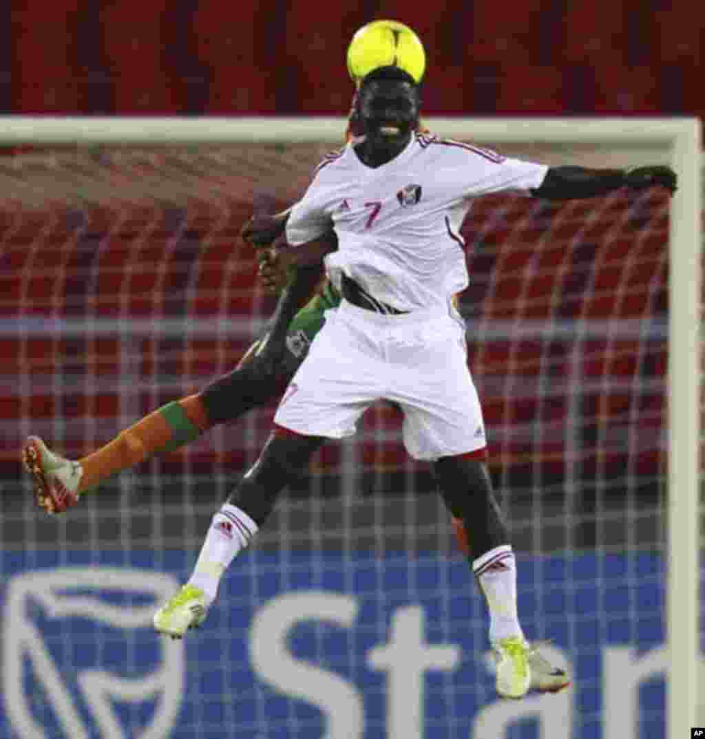 Chisamba Lungu of Zambia fights for the ball with Ramadan Alagab of Sudan (front) during their African Nations Cup quarter-final soccer match at Estadio de Bata "Bata Stadium", in Bata February 4, 2012.