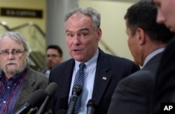 FILE - Democratic Sen. Tim Kaine, center, speaks to reporters on Capitol Hill in Washington, April 7, 2017.