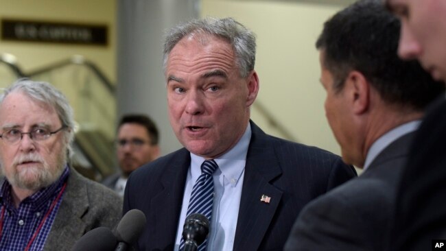 FILE - Democratic Sen. Tim Kaine, center, speaks to reporters on Capitol Hill in Washington, April 7, 2017.