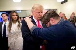 FILE - Pastor Joshua Nink, right, prays for then-Republican presidential candidate Donald Trump, after a Sunday service at First Christian Church, in Council Bluffs, Iowa, Jan. 31, 2016.