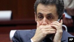 FILE - In this Dec.11, 2009 file photo, then French President Nicolas Sarkozy makes a phone call during a EU summit at the European Council building in Brussels.