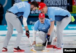 Skip John Shuster of the U.S. watches the shot as his teammates, lead John Landsteiner and second Matt Hamilton, sweep.The team won the first gold medal for curling in U.S history, Feb. 24, 2018, in Gangneung, South Korea.