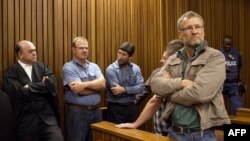 Some of the right-wing extremists convicted of high treason for a plot to kill former South African president Nelson Mandela and drive blacks out of the country attend their trial at Pretoria High Court on Oct. 29, 2013.