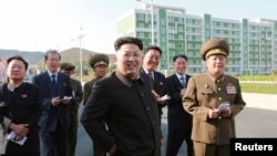 North Korean leader Kim Jong Un gives field guidance at the newly built Wisong Scientists Residential District in this undated photo released by North Korea's Korean Central News Agency (KCNA) in Pyongyang October 14, 2014.