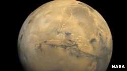 The largest canyon in the Solar System cuts a wide swath across the face of Mars. Named Valles Marineris, the grand valley extends more than 3,000 kilometers long, spans as much as 600 kilometers across, and delves as much as 8 kilometers deep. (Viking Project)