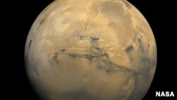 The largest canyon in the Solar System cuts a wide swath across the face of Mars.(NASA)
