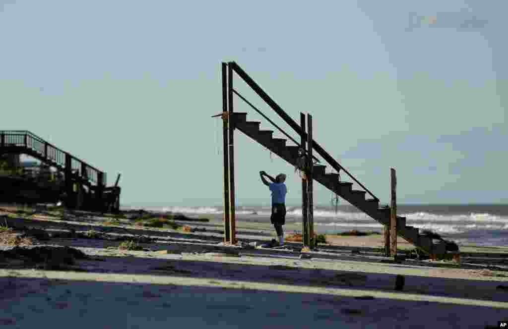 Ivan Juric takes photos of his damaged beach home at Ponte Vedra Beach, Florida, after Hurricane Matthew passed through on Friday.