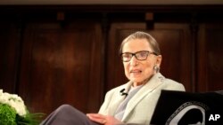 FILE - US Supreme Court Justice Ruth Bader Ginsburg sits on stage as the third speaker of the David Berg Distinguished Speakers Series, during an event organized by the Museum of the City of New York, Dec. 15, 2018.