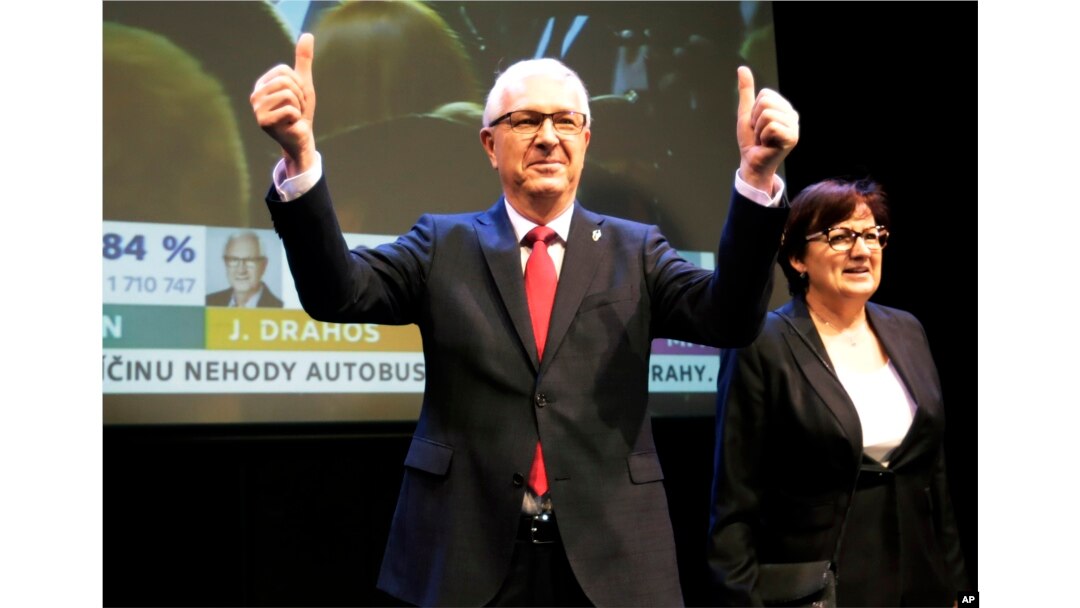 FILE - Presidential candidate Jiri Drahos, accompanied by his wife, Eva, arrives to address reporters after the announcement of preliminary results of the presidential elections in Prague, Czech Republic, Jan. 13, 2018.