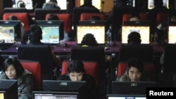 People use computers at an internet cafe in Wuhan, Hubei province.