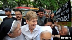 FILE - Australian missionary Patricia Anne Fox, center, is escorted by her colleagues before filing a petition calling for the review of her deportation case at the Department of Justice, in Padre Faura, Manila, Philippines, May 25, 2018. The immigration bureau had voided her visa following complaints from President Rodrigo Duterte about her participation in protest rallies. She ultimately lost her bid to stay and left the Philippines Nov. 3, 2018. 