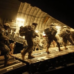 United States soldiers board a plane at Baghdad International Airport in July to start their trip home