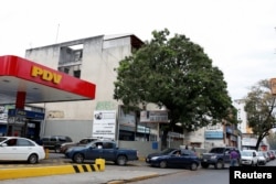 People wait in line to fill the tanks of their cars at a gas station of the state oil company PDVSA in Caracas, Venezuela, March 22, 2017.