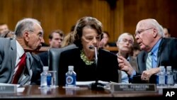 Senate Judiciary Committee Chairman Chuck Grassley, R-Iowa, left, and Sen. Dianne Feinstein, D-Calif., center, speaks with Sen. Patrick Leahy, D-Vt., during a Senate Judiciary Committee meeting on Sept. 13, 2018, in Washington.