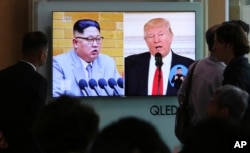 FILE - People watch a TV screen showing file footage of U.S. President Donald Trump, right, and North Korean leader Kim Jong Un during a news program at the Seoul Railway Station in Seoul, South Korea, April 21, 2018.
