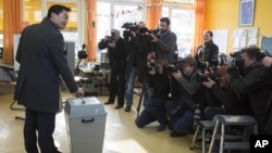 German Economy Minister and chairman of the German Free Democrats, Philipp Roesler, casts his ballot for the state election of Lower Saxony in Isernhagen, near Hannover, January 20, 2013. 