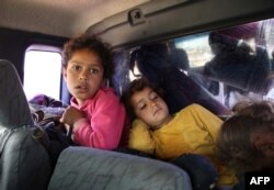Syrian children wait to leave their home following reported regime shelling on Hama and Idlib provinces, May 1, 2019.