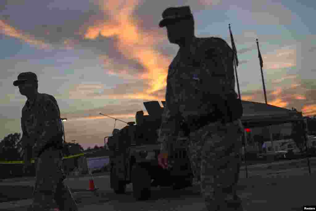 National Guard troops stand guard inside a shopping center parking lot in Ferguson, Missouri, Aug. 21, 2014.