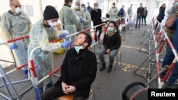 A medical employee presents how to collect a smear at a special corona test center for public service employees such as police officers, nurses and firefighters during a media presentation as the spread of the coronavirus disease (COVID-19) continues, in Munich, Germany, March 23