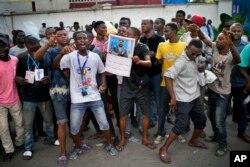 Congolese supporters of opposition presidential candidate Felix Tshisekedi stand outside the UDPS party headquarters in Kinshasa, Congo, Jan. 7, 2019.