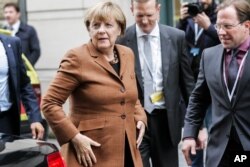 German Chancellor Angela Merkel arrives for a European Peoples Party , EPP , meeting, ahead of an emergency EU heads of state summit on migration, in Brussels on Sept. 23, 2015.