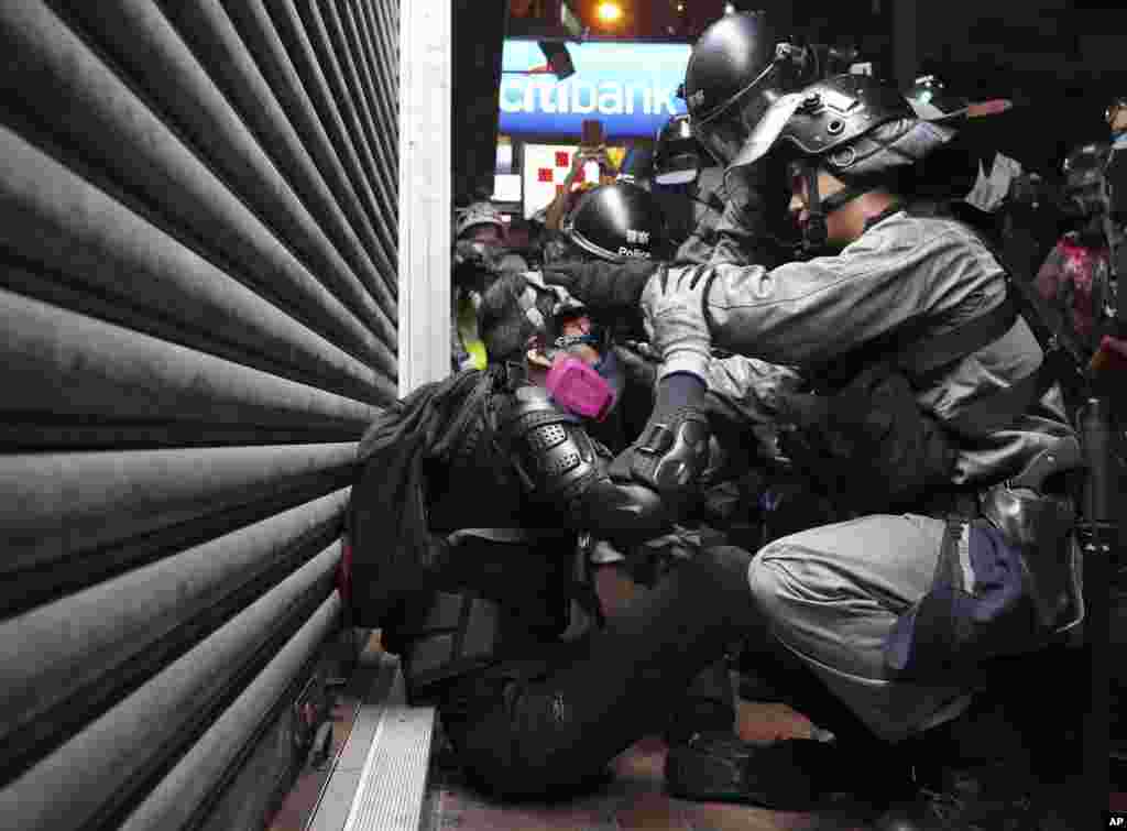 Riot police detain an injured protester during a pro-democracy protest in causeway bay, Hong Kong, Aug. 31, 2019.