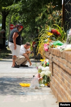 Sue Goodstar and JR Bobbick, both of the Native Lives Matter movement, pay respects to Justine Damond who was fatally shot by a Minneapolis police officer in Minneapolis, Minnesota, July 17, 2017.