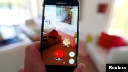 FILE - The augmented reality mobile game "Pokemon Go" by Nintendo is shown on a smartphone screen in this photo illustration taken in Palm Springs, California, July 11, 2016.