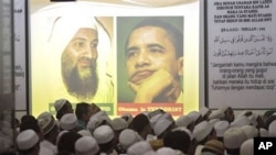 Portrait of Osama Bin Laden and U.S. President Barack Obama are projected on a screen during a prayer for the slain al-Qaida leader at the headquarters of hardline group Islam Defenders Front (FPI) in Jakarta, Indonesia, May 4, 2011