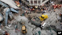 Excavator machines remove debris of a partially collapsed overpass in Kolkata, India, April 1, 2016. 