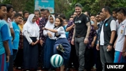 UNICEF Goodwill Ambassador David Beckham plays football with students and teachers at the SMPN 17 school in Semarang, Indonesia, March 27, 2018.