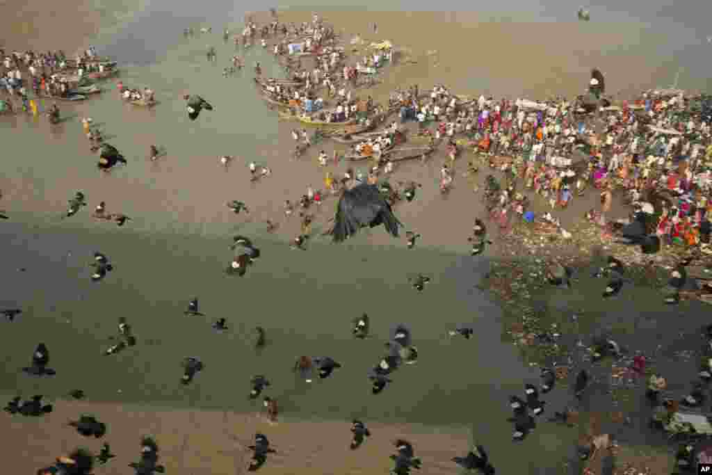 Indian Hindu devotees perform morning rituals in the Ganges River on the first day of the nine-day Navratri festival in Allahabad, India.