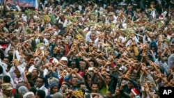 FILE - In this Sunday, Oct. 2, 2016 file photo, protesters chant slogans against the government during a march in Bishoftu, in the Oromia region of Ethiopia.