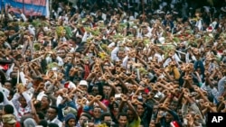 FILE - In this Sunday, Oct. 2, 2016 file photo, protesters chant slogans against the government during a march in Bishoftu, in the Oromia region of Ethiopia.