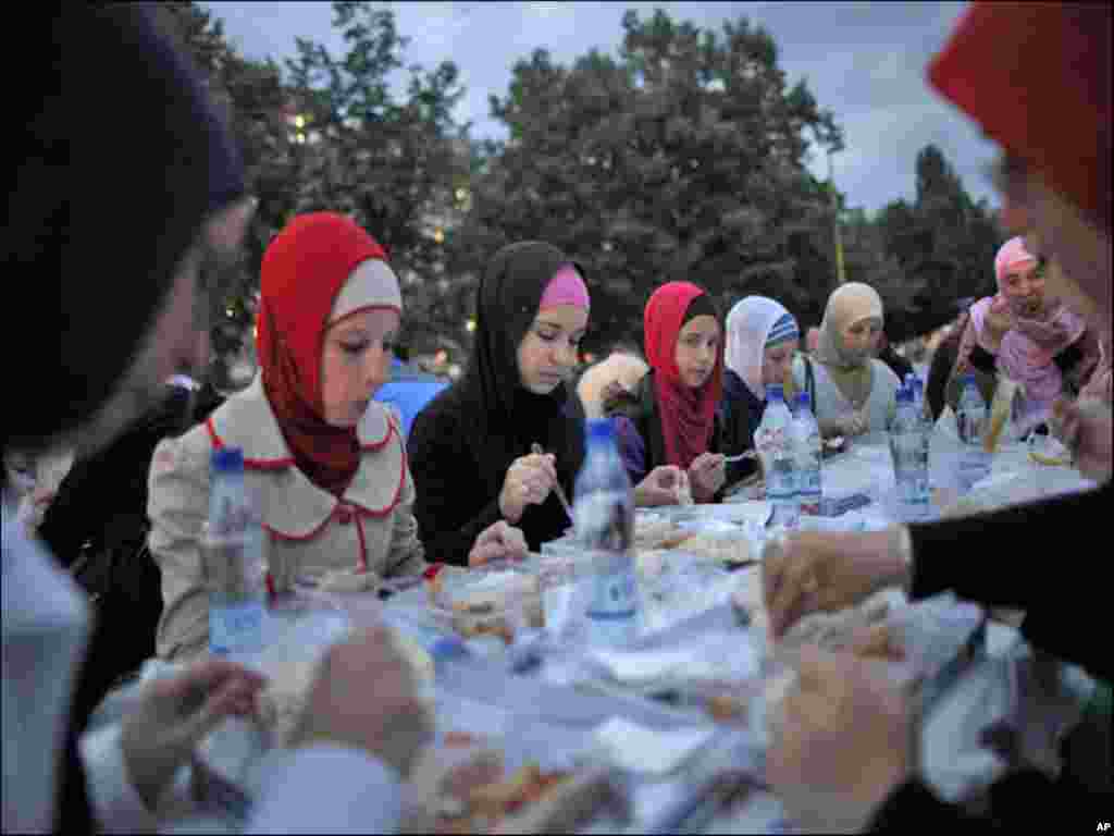 Women break their fast at the end of the third day of Islam's holy month of Ramadan in the central Bosnian town of Zenica.