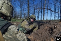 Ukrainian military servicemen control their position during a ceasefire outside Avdiivka, eastern Ukraine, April 16, 2016.