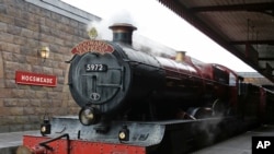 A real cloak of invisibility? What's next? A magic train that takes you to the Hogwarts school? Oh, wait. That's in Florida! The Hogwarts Express arrives the station at the Wizarding World of Harry Potter at Universal Orlando, 2014. (AP Photo/John Raoux)