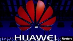 FILE - The Huawei logo is seen during the Mobile World Congress in Barcelona, Spain, Feb. 26, 2018.