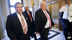 U.S. Reps. Mike Rogers, R-Michigan, left, and Billy Long, R-Missouri, center, arrive for votes on Capitol Hill on President Barack Obama's executive action on immigration, Dec. 4, 2014.