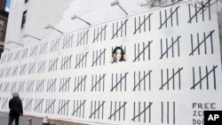 Karya seni setinggi 20 meter karya seniman grafiti Banksy di New York untuk menarik perhatian dunia terhadap penahanan pelukis Turki berdarah Kurdi, Zehra Dogan, 16 Maret 2018. (Foto: Dennis Van Tine/Star Max).