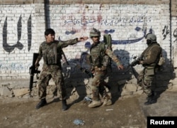 Afghan National Army (ANA) soldiers arrive after a blast near the Pakistani consulate in Jalalabad, Afghanistan, Jan. 13, 2016.