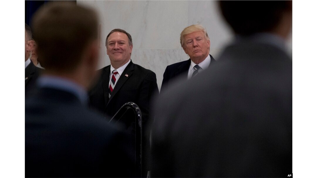 FILE - President Donald Trump, accompanied by CIA Director-designate Mike Pompeo, left, waits to speak at the Central Intelligence Agency in Langley, Va., Jan. 21, 2017.