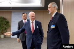 The United Nations Special Envoy for Syria, Staffan de Mistura, center,welcomes Bashar al-Jaafari, Syrian U.N. Ambassador, prior to a round of negotiations during the Intra Syria talks, at the European headquarters of the United Nations in Geneva, Switzerland