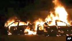 Image taken from amateur video shows burning cars after being attacked by supporters of Syrian President Bashar al-Assad, in Homs Syria, December 13, 2011.
